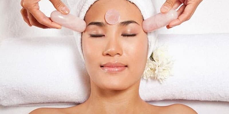 A woman having a stone facial massage